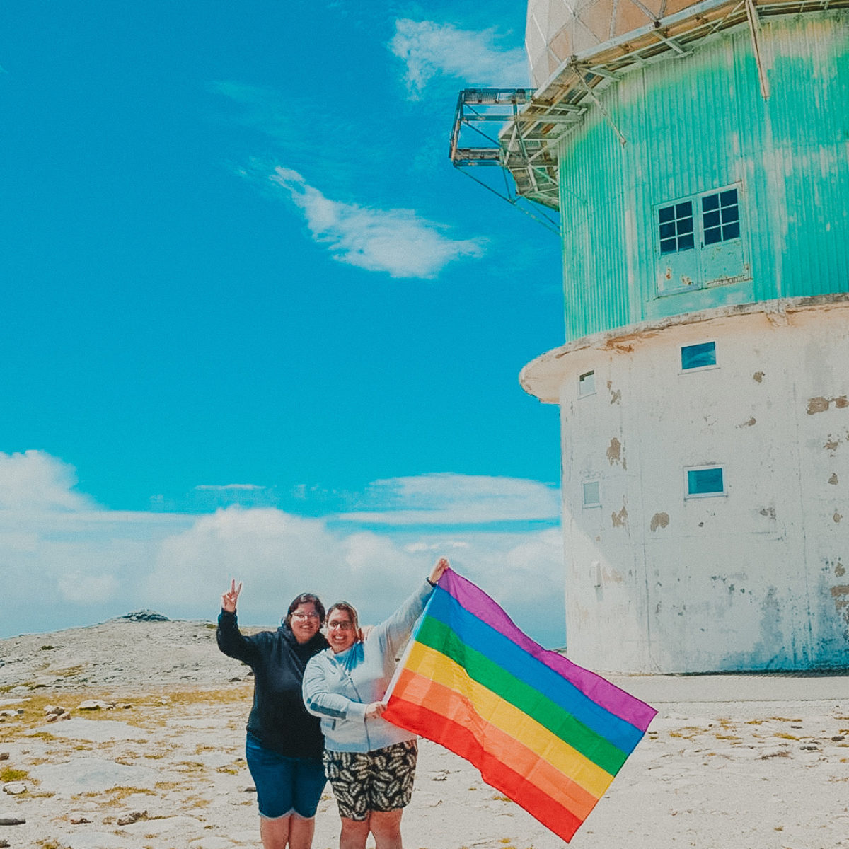 Lesbian couple holding rainbow flag in Portugal